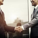 Corporate businessmen shaking hands
