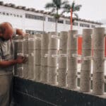 Técnico da Concreserv identificando corpos de prova cilíndricos de concreto com etiquetas e anotações, processo essencial para rastreabilidade e controle de qualidade do material.