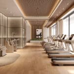 Academia de luxo equipada com aparelhos Technogym Artis Luxury, ambiente sofisticado com iluminação natural e design contemporâneo.