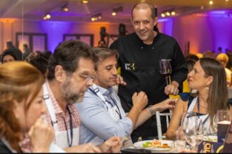 Chef interage com executivos durante jantar de networking do Hub C3, promovendo integração e experiências exclusivas no setor da construção civil.