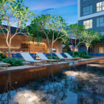 Área de lazer de condomínio com piscina, espreguiçadeiras e mobiliário outdoor Tidelli, destacando design contemporâneo e integração com paisagismo.