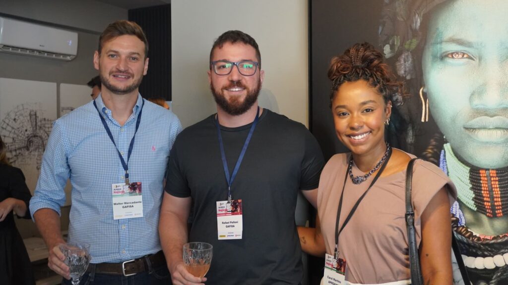 Walter Mercadante e Rafael Palloni, da GAFISA, e Carol Martins, do APROXIMA, posam sorridentes durante o 60° Almoço de Negócios C3, simbolizando integração e networking no setor da construção civil.