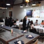 Profissionais da construção civil participam do 62° Almoço de Negócios C3 na Experience Lounge, em São Paulo, reunidos em mesas para networking e integração.