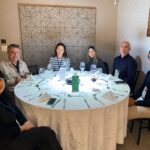 Grupo de profissionais da construção civil reunidos ao redor de uma mesa redonda durante o 65° Almoço de Negócios do C3, em ambiente elegante e descontraído.