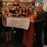 Lançamento do livro de Marcos Bigucci em Orlando, com destaque para a entrega simbólica de doação à Florida Guardian ad Litem Foundation, instituição que apoia crianças em situação de vulnerabilidade.